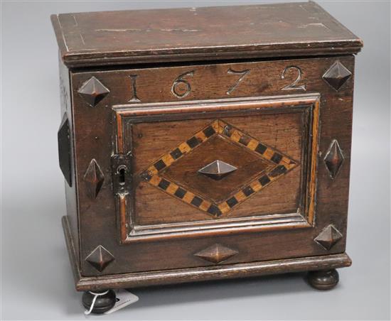 An inlaid oak spice cabinet, carved with the date, 1672 W.29cm